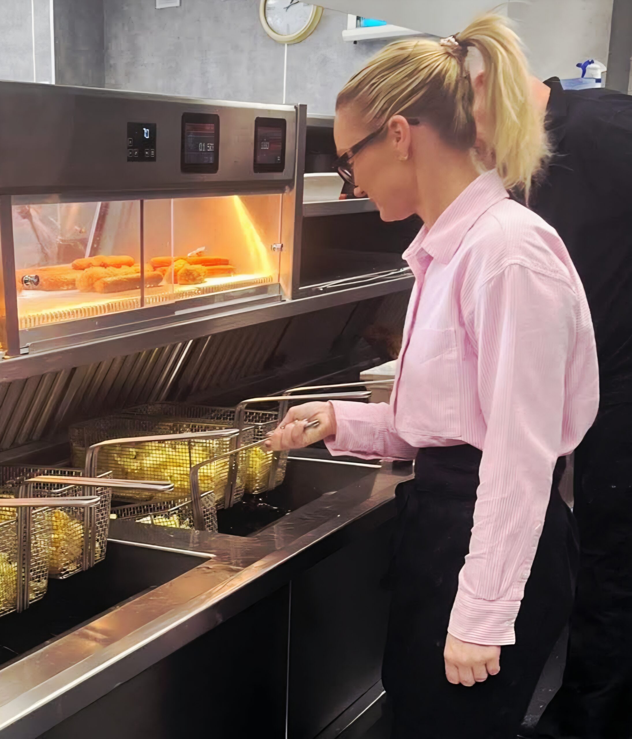 FB_IMG_1784627175796 Staff frying chips at Elite Fish & Chip Company